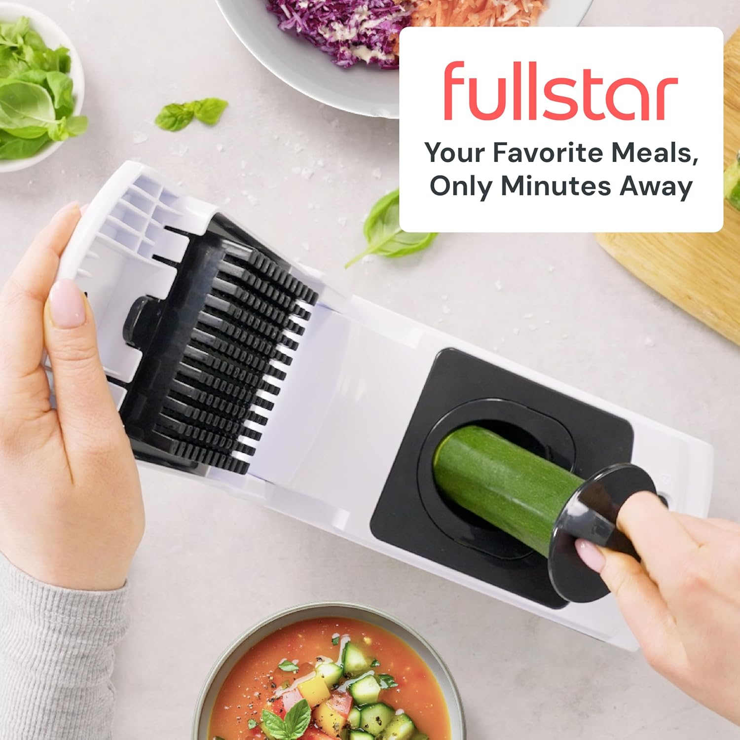 Person using a vegetable chopper with 'fullstar' branding in the background.